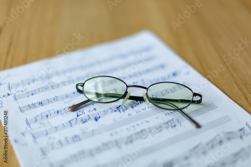 musical manuscript with notes  glasses in the background
