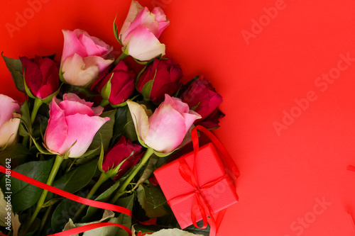 Romantic still life, red roses on a red background. Postcard Concept for Women's Day and Valentine's Day. Copy space. 