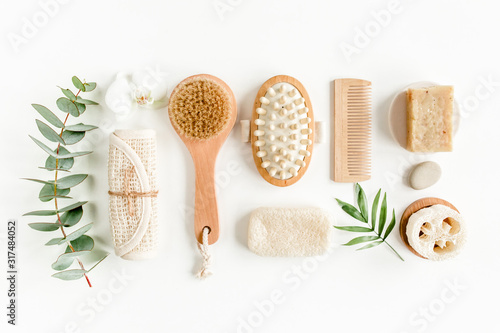 Spa Background. Natural/Organic spa cosmetics products, eco friendly bathroom accessories, palm leaves. Skincare concept on white background. Flat lay, top view