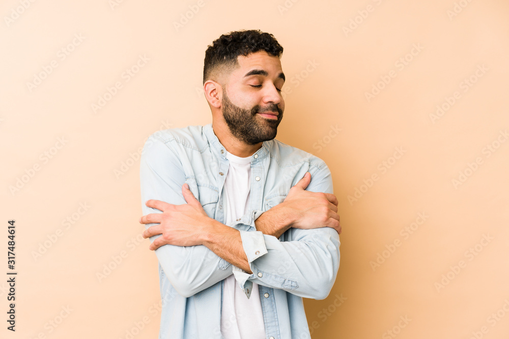 Young mixed race arabic man isolated hugs, smiling carefree and happy. Young mixed race arabic man isolated hugs, smiling carefree and happy.