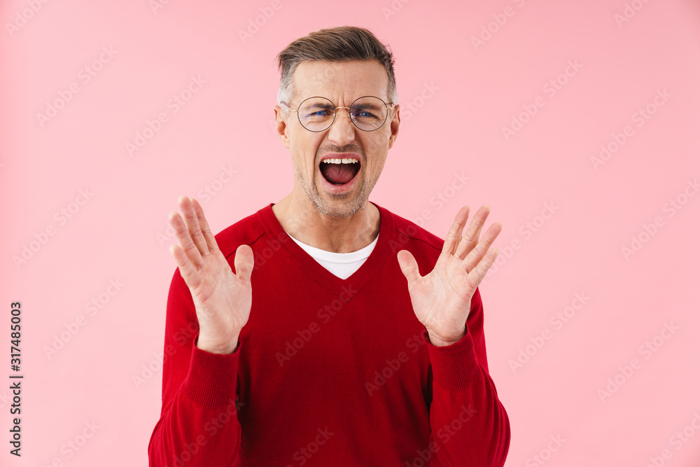 Portrait of handsome caucasian man screaming and raising hands Portrait of handsome caucasian man screaming and raising hands