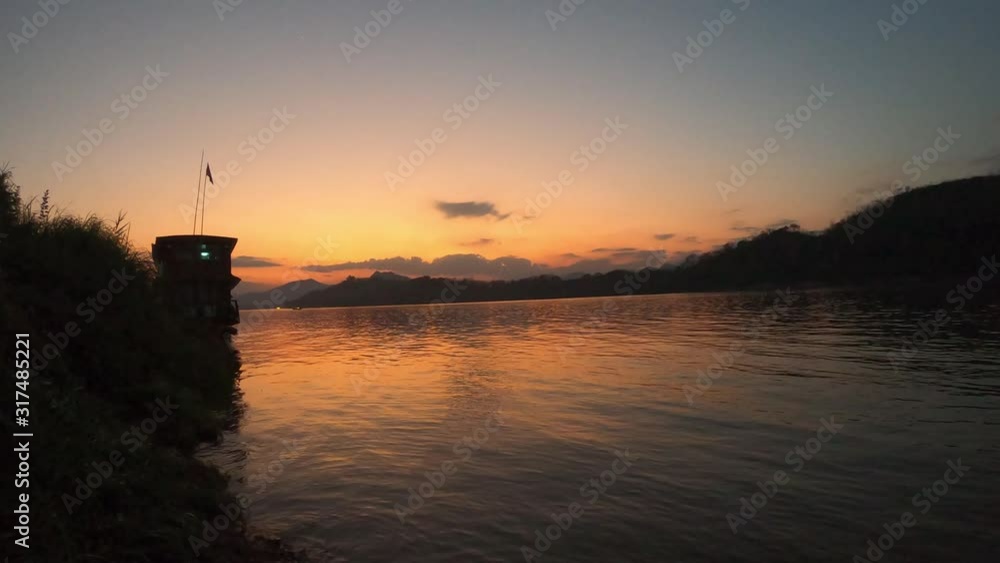 Docked slow boat by the Mekong river at sunset, Luang Prabang, Laos Docked slow boat by the Mekong river at sunset, Luang Prabang, Laos