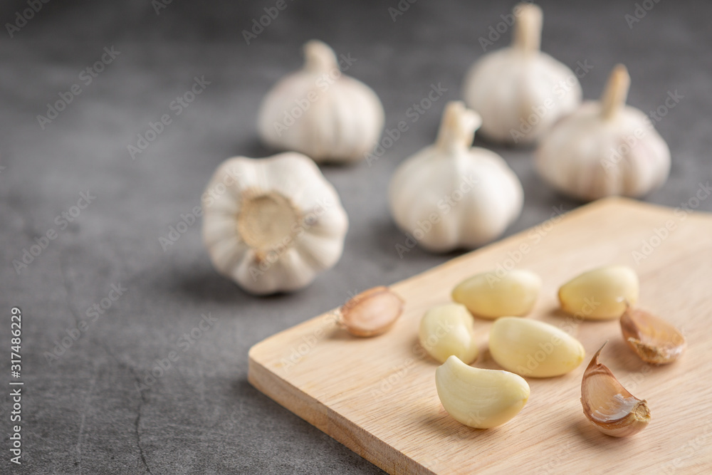 Garlic on the black cement floor. High angle view. Garlic on the black cement floor. High angle view.