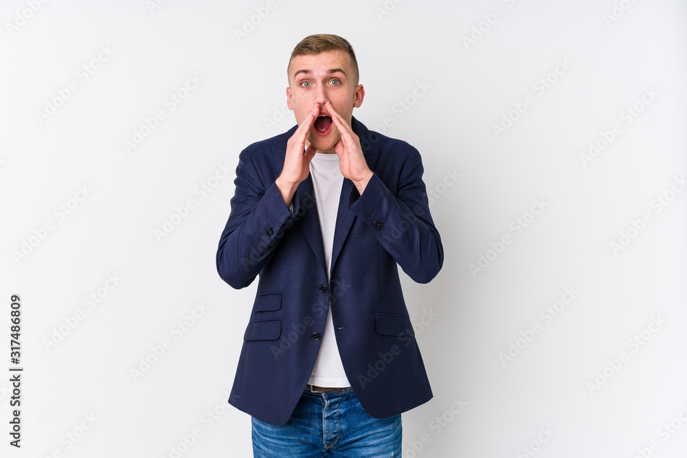 Young business caucasian man shouting excited to front.