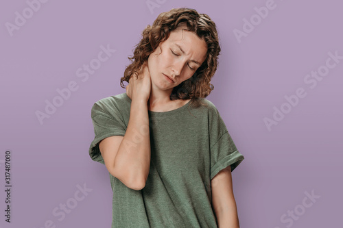 Принти на полотні Tired upset young caucasion woman suffering from fatigued massaging hurt stiff n