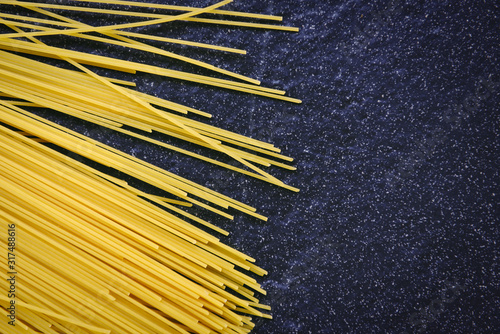 raw spaghetti italian pasta uncooked spaghetti yellow long ready to cook in the restaurant italian food and menu