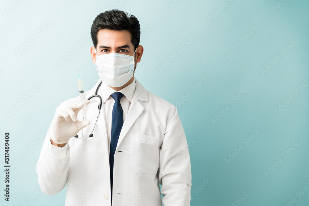 Male Healthcare Worker With Syringe In Studio Male Healthcare Worker With Syringe In Studio