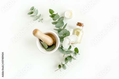 Spa Background. Natural/Organic spa cosmetics products, eco friendly bathroom accessories, eucalyptus leaves. Skincare concept on white background. Flat lay, top view