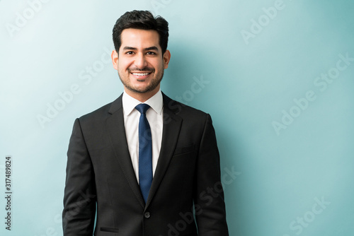 Handsome Hispanic Businessman In Black Suit At Studio
