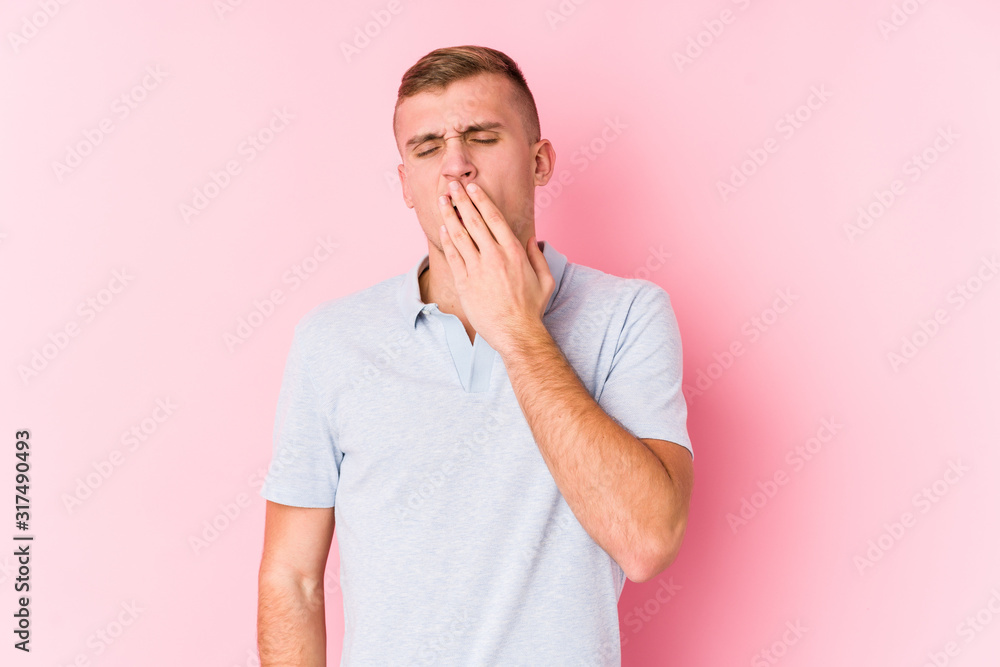 Young caucasian man isolated yawning showing a tired gesture covering mouth with hand. Young caucasian man isolated yawning showing a tired gesture covering mouth with hand.