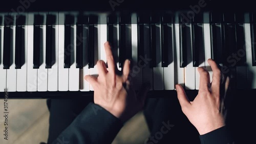 Close-up of pianist's hands professionally play the piano