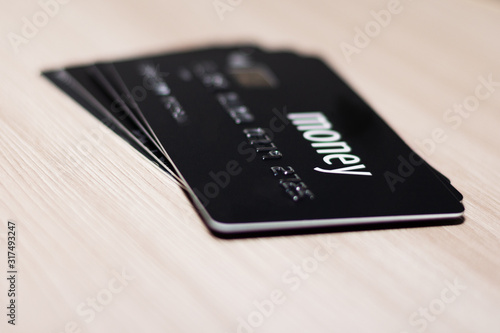 Credit card in black with the inscription money. Plastic card. Credit card payment.