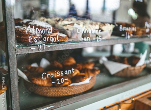 Fresh croissants at bakery display shelf
