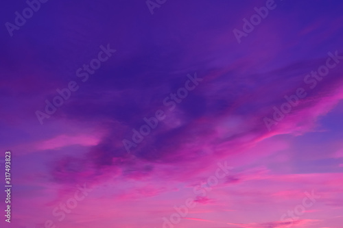 Colorful clouds in summer evening sky. Bright and pink clouds in sky sunset or sunrise. Beautiful purple pink evening sky background. © Papin_Lab