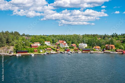 Slika na platnu Cozy Scandinavian cottages located on the coastline of the archipelago in Sweden