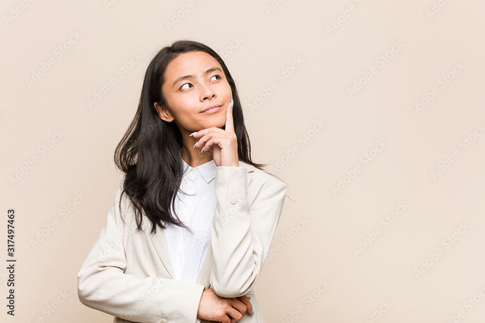 Young business chinese woman looking sideways with doubtful and skeptical expression. Young business chinese woman looking sideways with doubtful and skeptical expression.