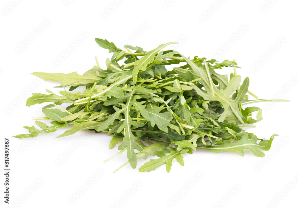 Arugula leaves on a heap, salad isolated on a white background Arugula leaves on a heap, salad isolated on a white background