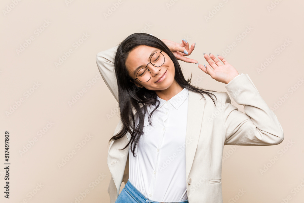 Young business chinese woman stretching arms, relaxed position. Young business chinese woman stretching arms, relaxed position.