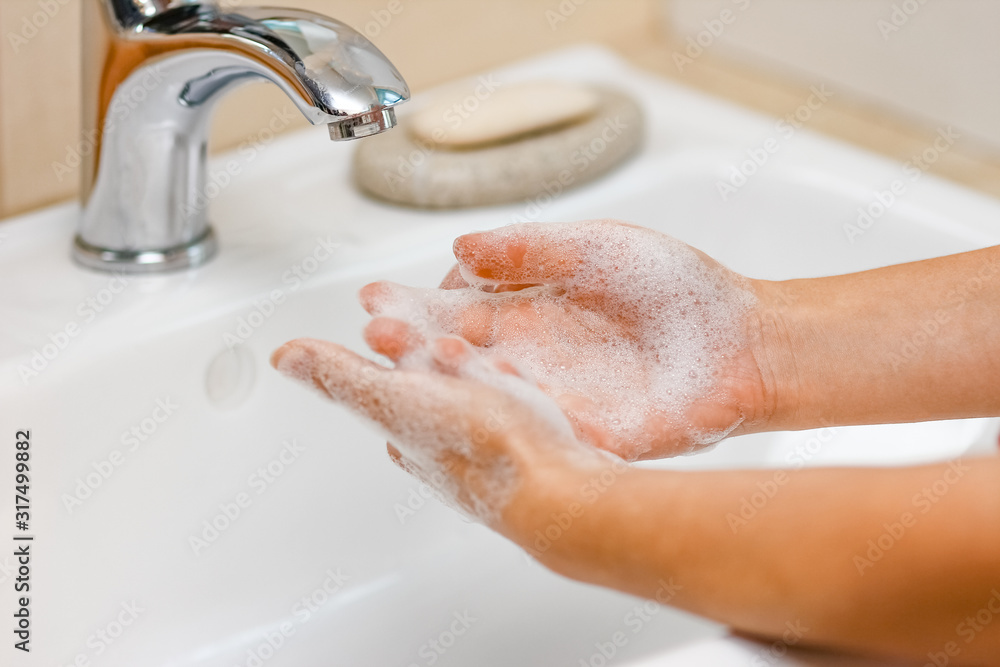Hygiene concept. Washing hands with soap under the faucet with water Hygiene concept. Washing hands with soap under the faucet with water