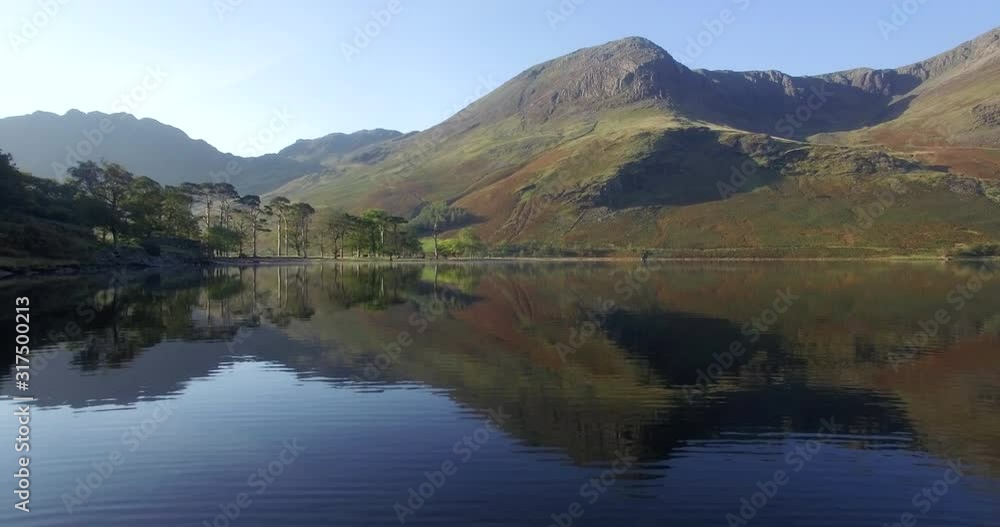 The Lake Buttermere pines and peaks of High Crags, Lake District National Park, Cumbria, England, United Kingdom, Europe The Lake Buttermere pines and peaks of High Crags, Lake District National Park, Cumbria, England, United Kingdom, Europe