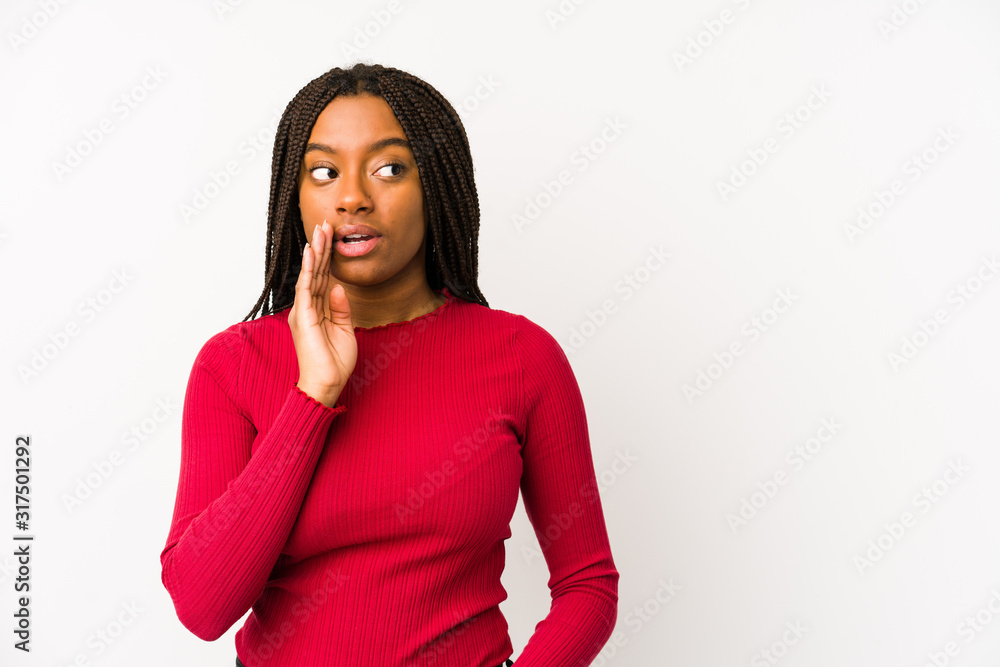 Young african american woman isolated is saying a secret hot braking news and looking aside Young african american woman isolated is saying a secret hot braking news and looking aside