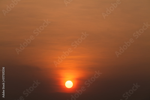 Sunset orange sky background at evening with clouds © ณรงค์พล ไชยบุตร