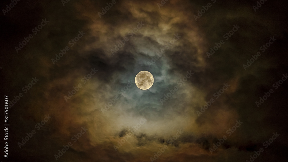 Bright full moon in the cloudy sky Bright full moon in the cloudy sky
