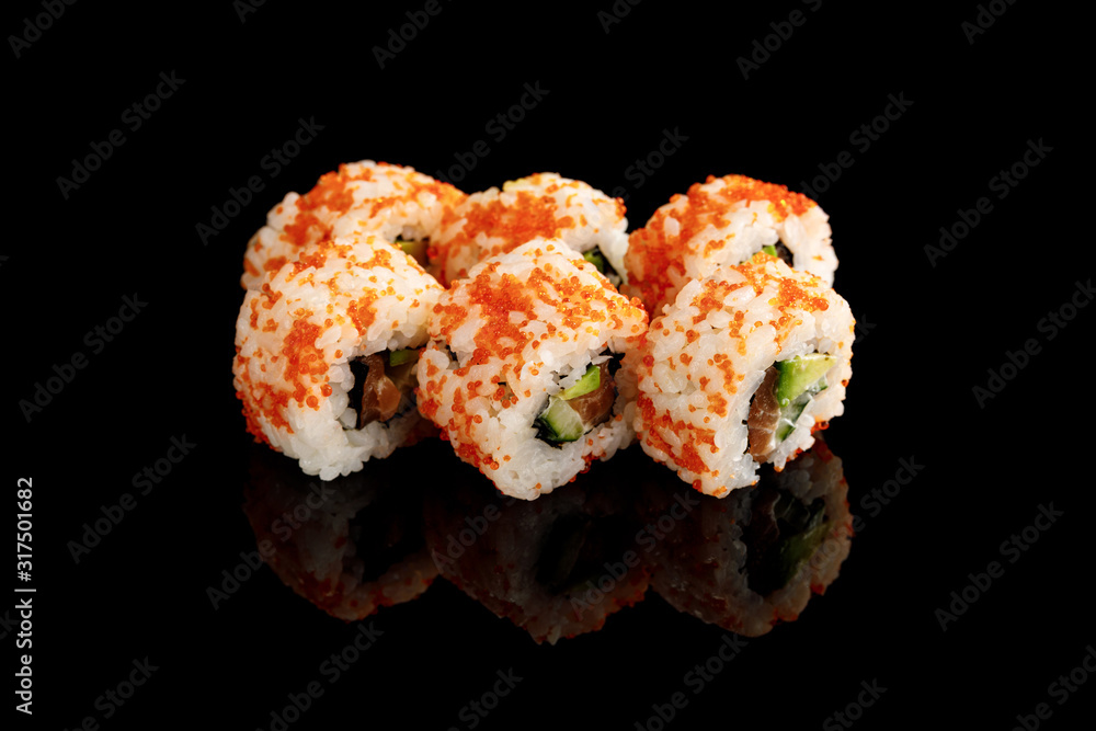 delicious California roll with avocado, salmon and masago caviar isolated on black delicious California roll with avocado, salmon and masago caviar isolated on black