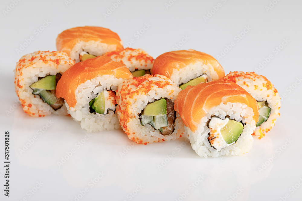delicious Philadelphia and California sushi with salmon and masago caviar on white background delicious Philadelphia and California sushi with salmon and masago caviar on white background