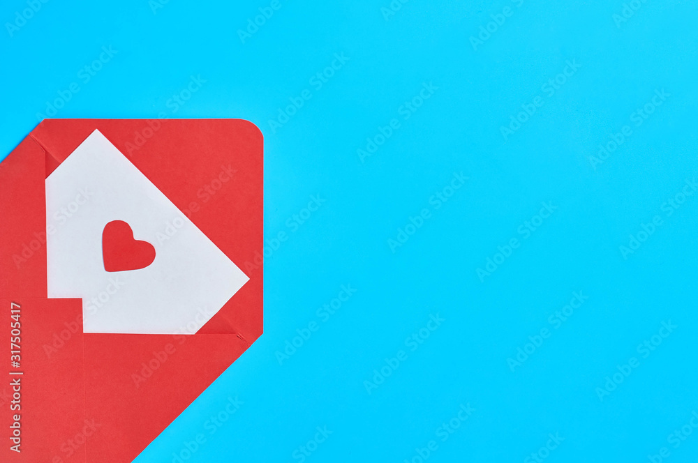Open postal envelope with blank white paper and red heart on blue desk. Love message. Concept of Valentines Day. Space for text. Top view Open postal envelope with blank white paper and red heart on blue desk. Love message. Concept of Valentines Day. Space for text. Top view