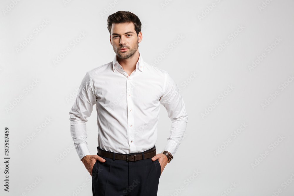 Image of young caucasian businessman posing and looking at camera Image of young caucasian businessman posing and looking at camera