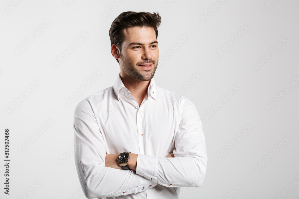 Image of young happy businessman posing and smiling Image of young happy businessman posing and smiling