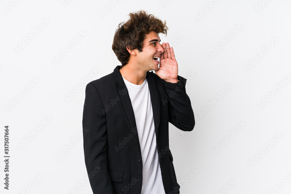 Young caucasian business man against a white background isolated shouting and holding palm near opened mouth. Young caucasian business man against a white background isolated shouting and holding palm near opened mouth.