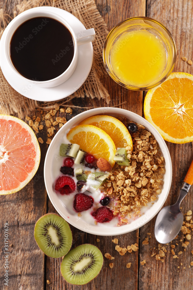 breakfast with muesli, fruit, coffee cup and orange juice breakfast with muesli, fruit, coffee cup and orange juice