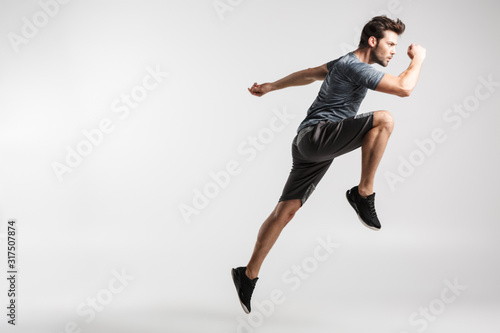 Image of young athletic man doing exercise while working out