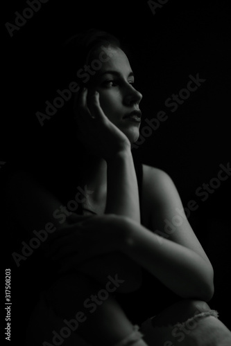 Studio portrait of a beautiful brunette on a black background