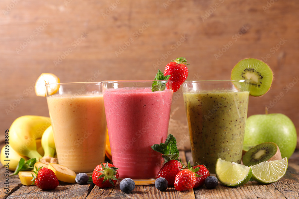 glasses of fruit smoothies with berries fruits, banana, apple glasses of fruit smoothies with berries fruits, banana, apple
