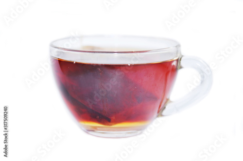 Transparent cup of black tea isolated on white background