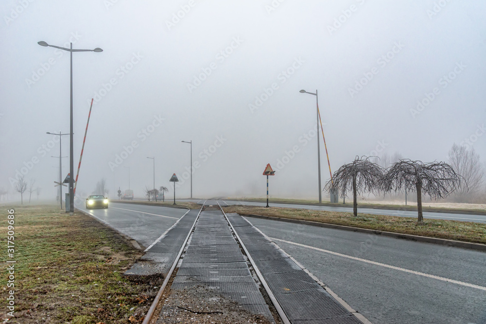 Novi Sad, Serbia - January 16, 2020: Railroad across the street. Railroad crossing in Serbia 