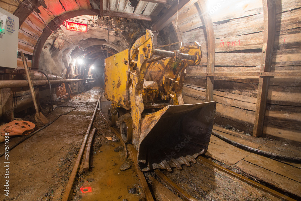 Fototapeta premium Gold mine tunnel with loading machine eimco