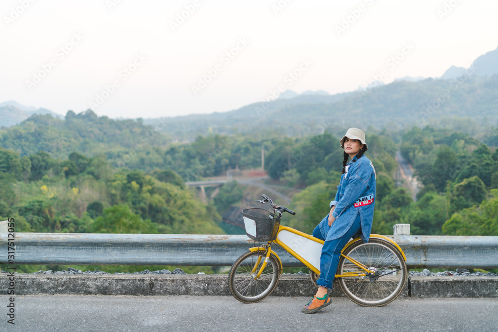 Fototapeta premium young couple sitting on their bicycles looking at mountain
