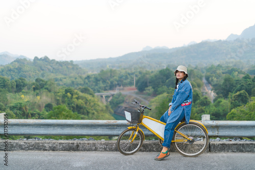 young couple sitting on their bicycles looking at mountain
