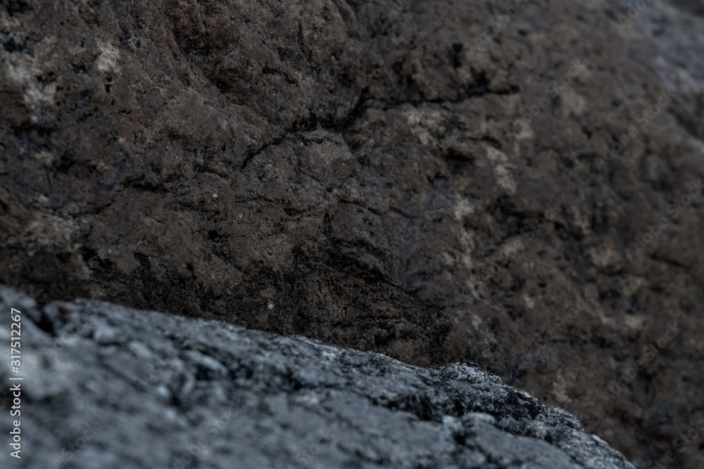 Piles of boulders spread all over the coast; Macro texture of granite and sand Piles of boulders spread all over the coast; Macro texture of granite and sand