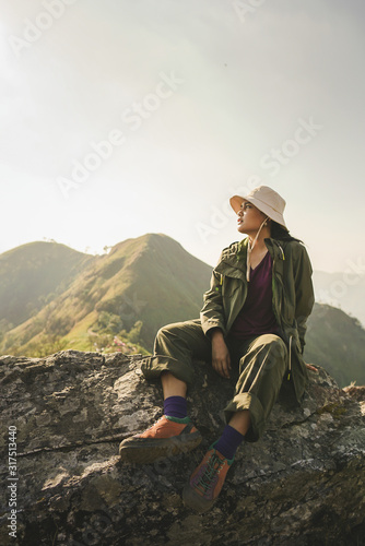 A female hiker sitting on the rock over the mountain ©  Berlin23