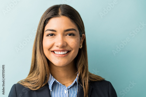 Pretty Hispanic Businesswoman Smiling In Studio photo