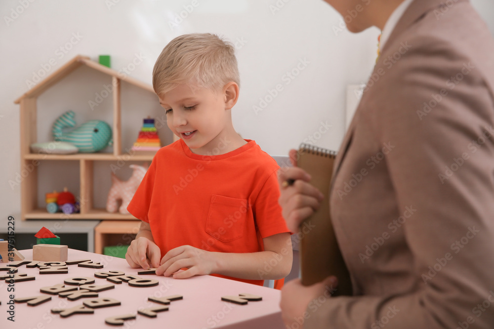 Speech therapist working with little boy in office Speech therapist working with little boy in office