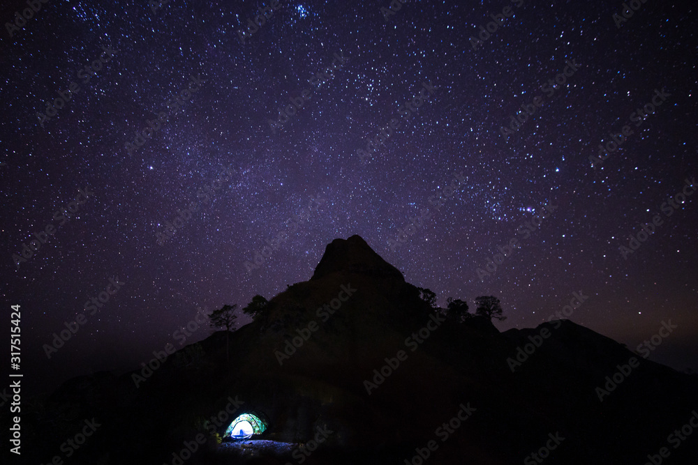 Lighted tent on the mountain at starry night Lighted tent on the mountain at starry night