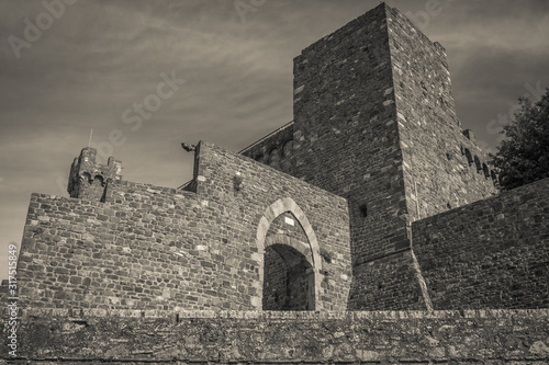 Black and white view of the arch for the entrance in Montalcino medieval town, Tuscany