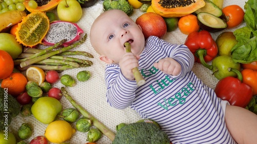 Funny Baby Trying Asparagus And Frowning. Supplementary Food And New Taste Concept. © di_media