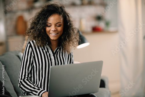 Beautiful mixed race student studying online. Businesswoman working from home. 